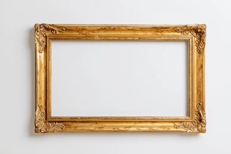 Ornate gold picture frame with aged finish hanging on white wall