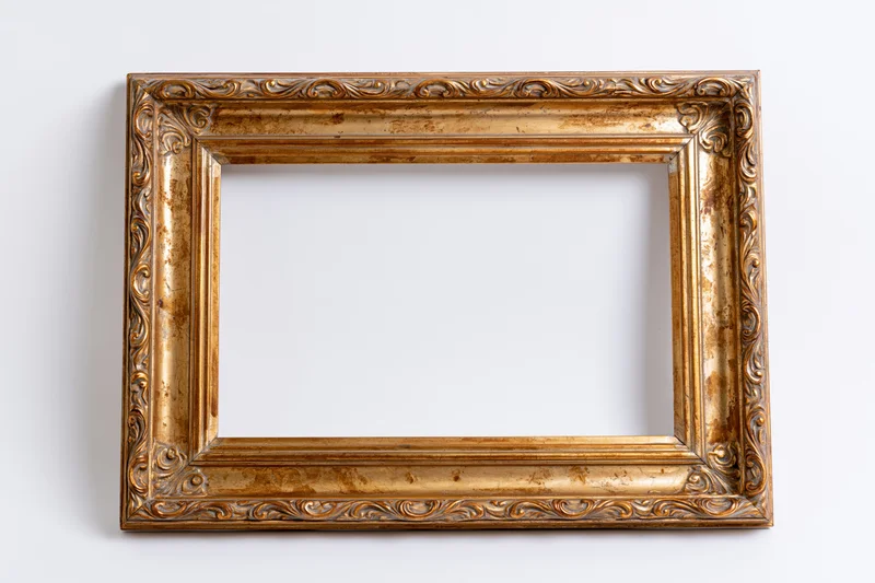 Ornate gold picture frame with aged finish hanging on white wall