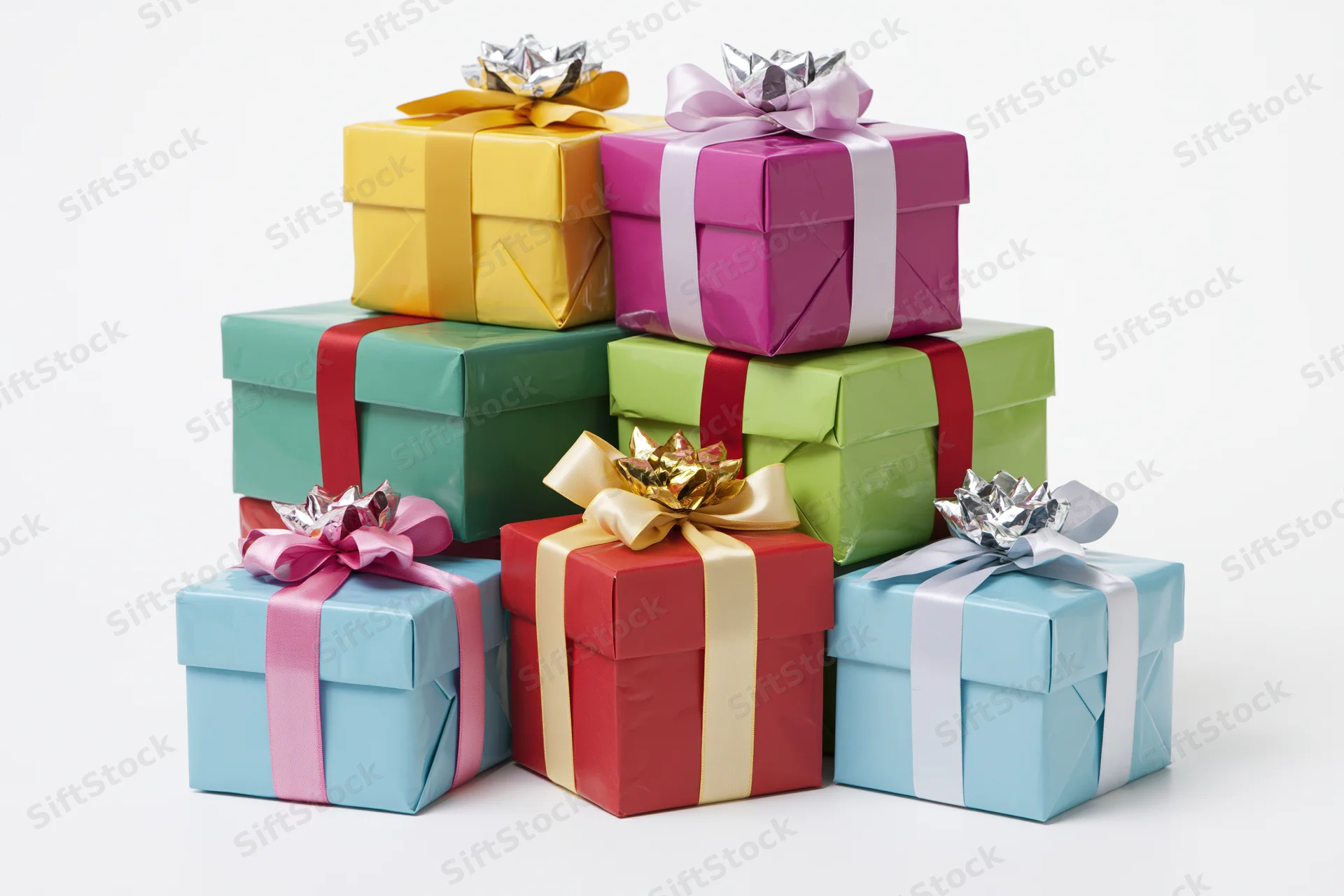 Stack of six colorful wrapped gift boxes grouped together on white background