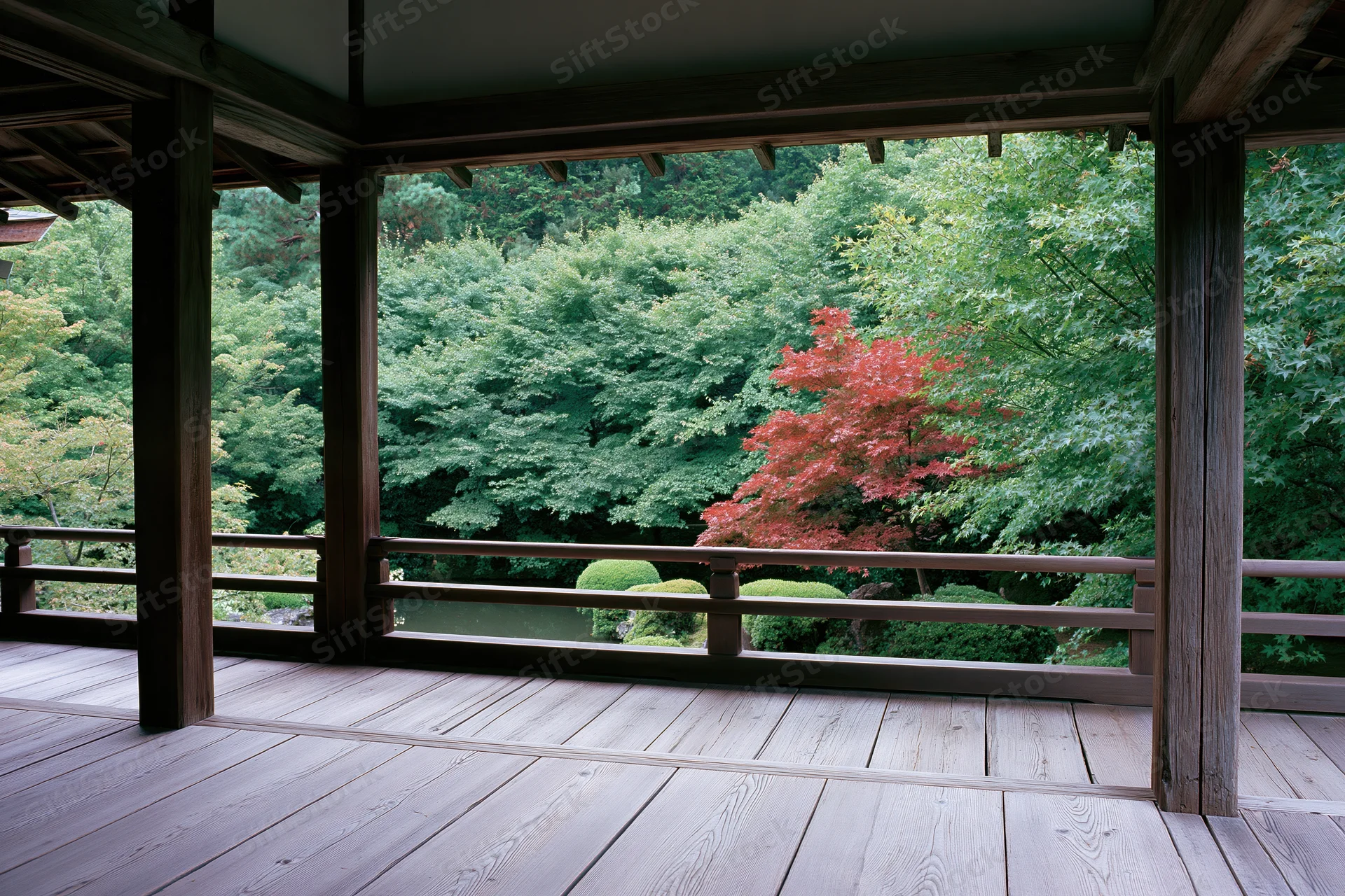 View from a traditional japanese temple veranda overlooking a garden with red maple trees in autumn
