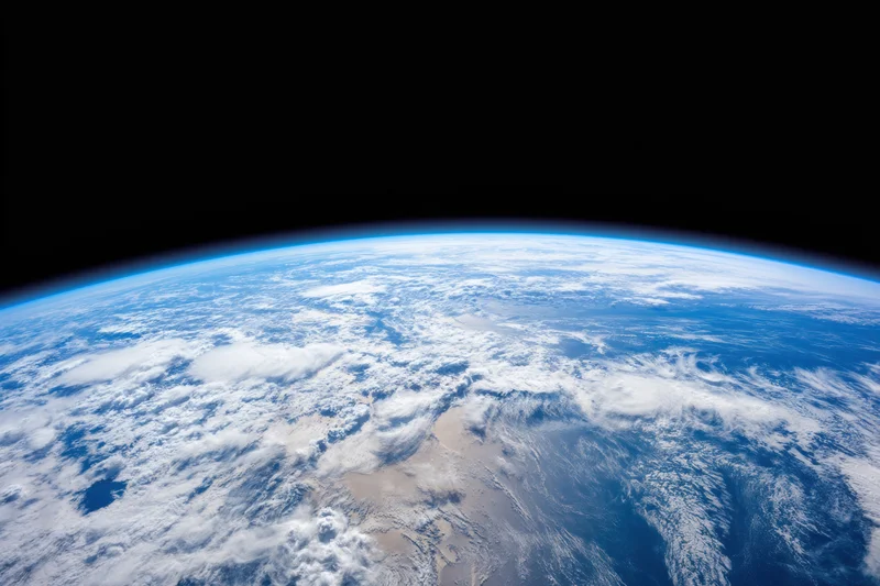 Earth viewed from orbit showing blue oceans, white clouds and landmasses against black space