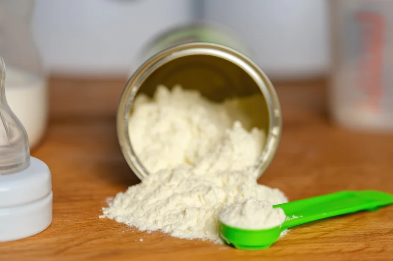Close up of a baby feeding scene with formula powder spilled