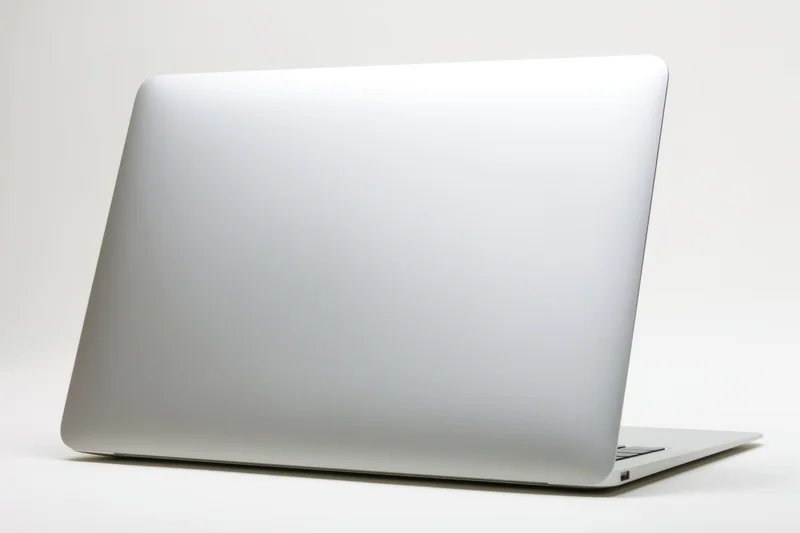 Closed silver laptop viewed from the back on a white background