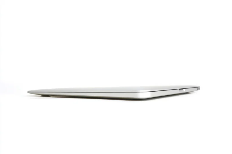 Closed silver laptop viewed from the back on a white surface