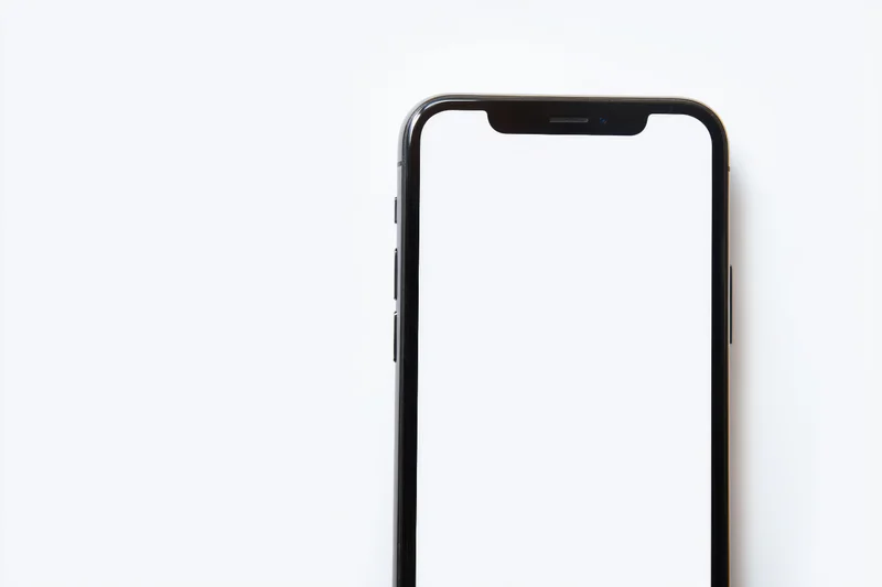 Black smartphone with rounded edges and notch displaying blank white screen against white background