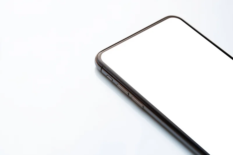 Close-up of a modern smartphone corner showing screen edge and side buttons on white background