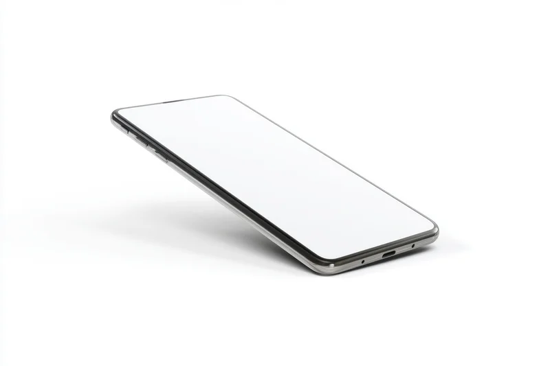 Smartphone lying flat on white surface with blank screen and metallic frame