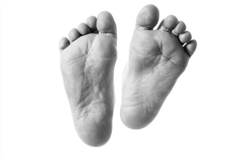 Two bare human feet viewed from above on a white background