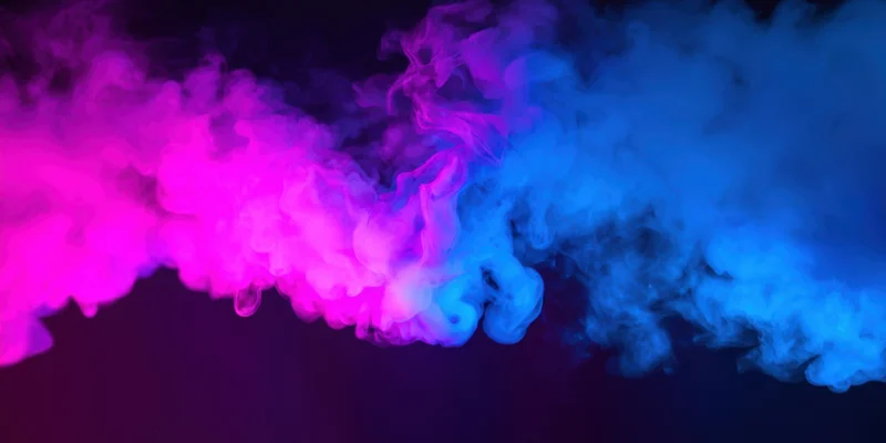 Billowing pink and blue smoke spreading across a dark background