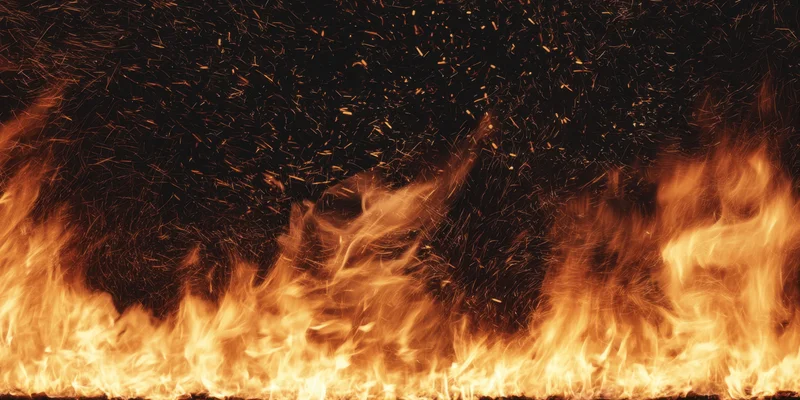 Blazing fire erupts along lower edge with orange and gold flames and rising sparks against dark backdrop