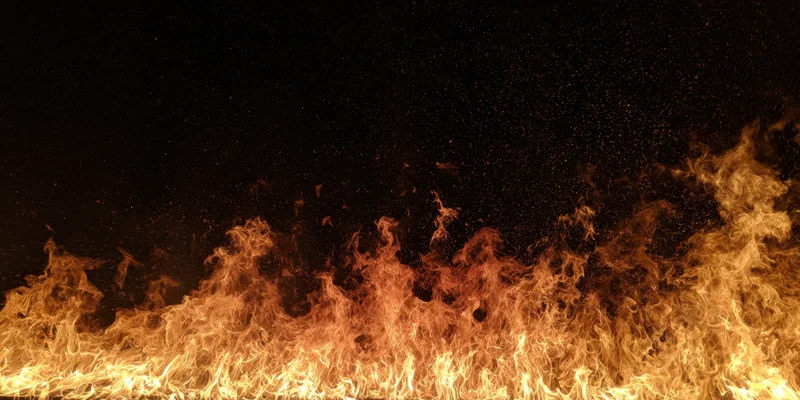 Flames erupting along the lower edge against a dark background