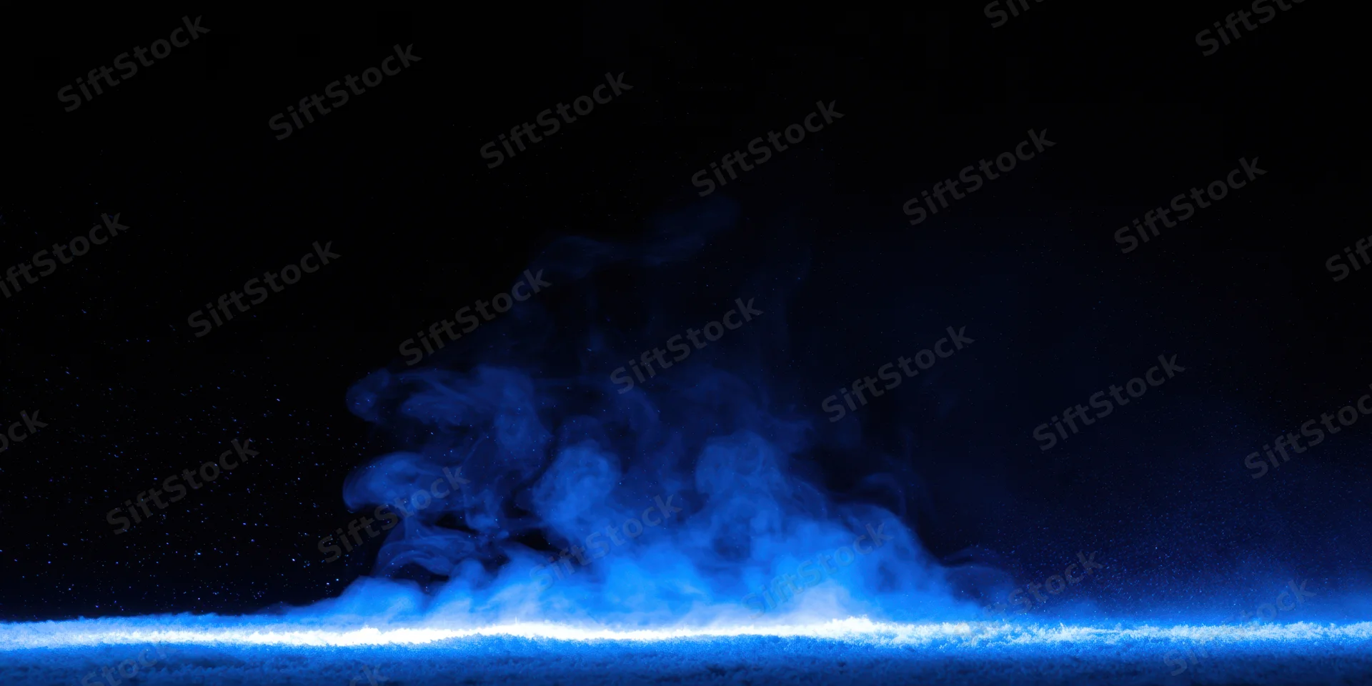 Wispy blue smoke rising above a glowing horizontal light strip in a dark space