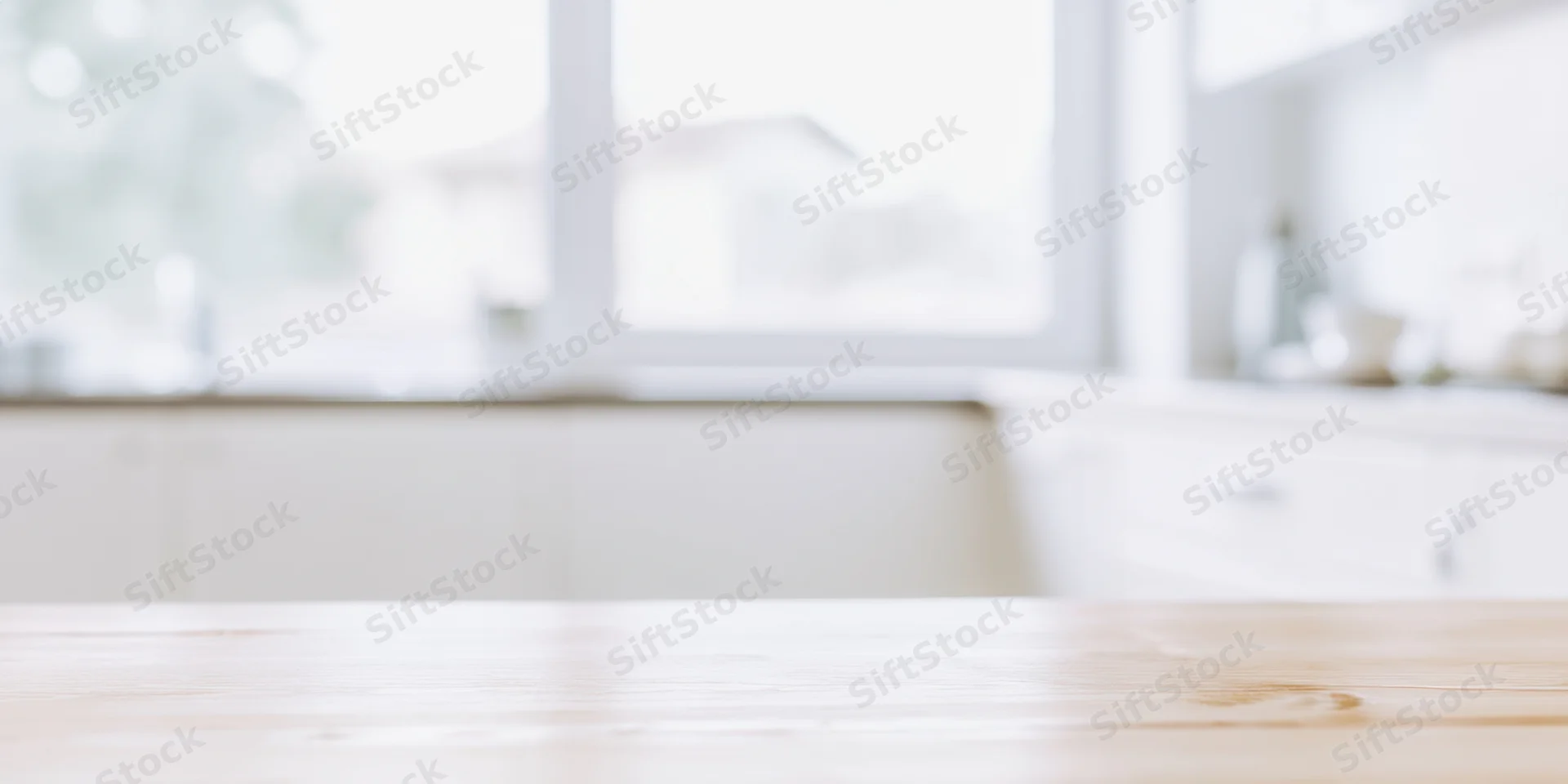 Smooth light wooden table in a bright minimalist kitchen interior