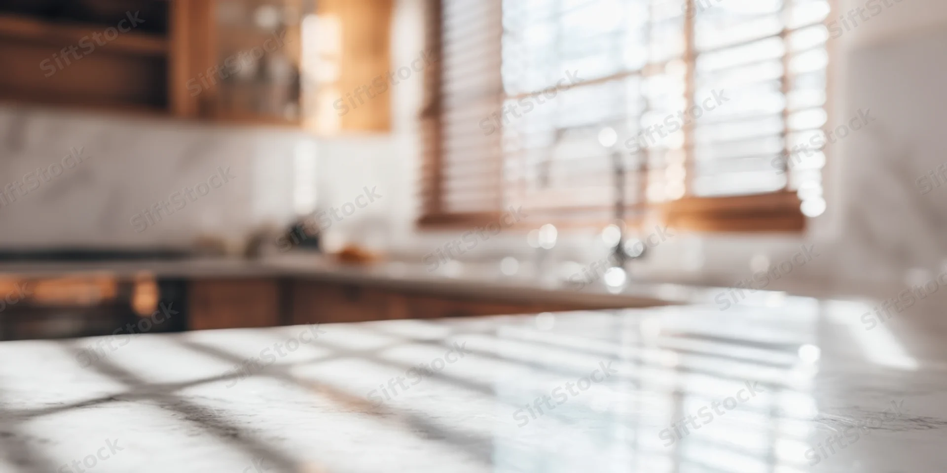 White marble countertop in a bright minimalist kitchen with sunlight filtering through wooden blinds