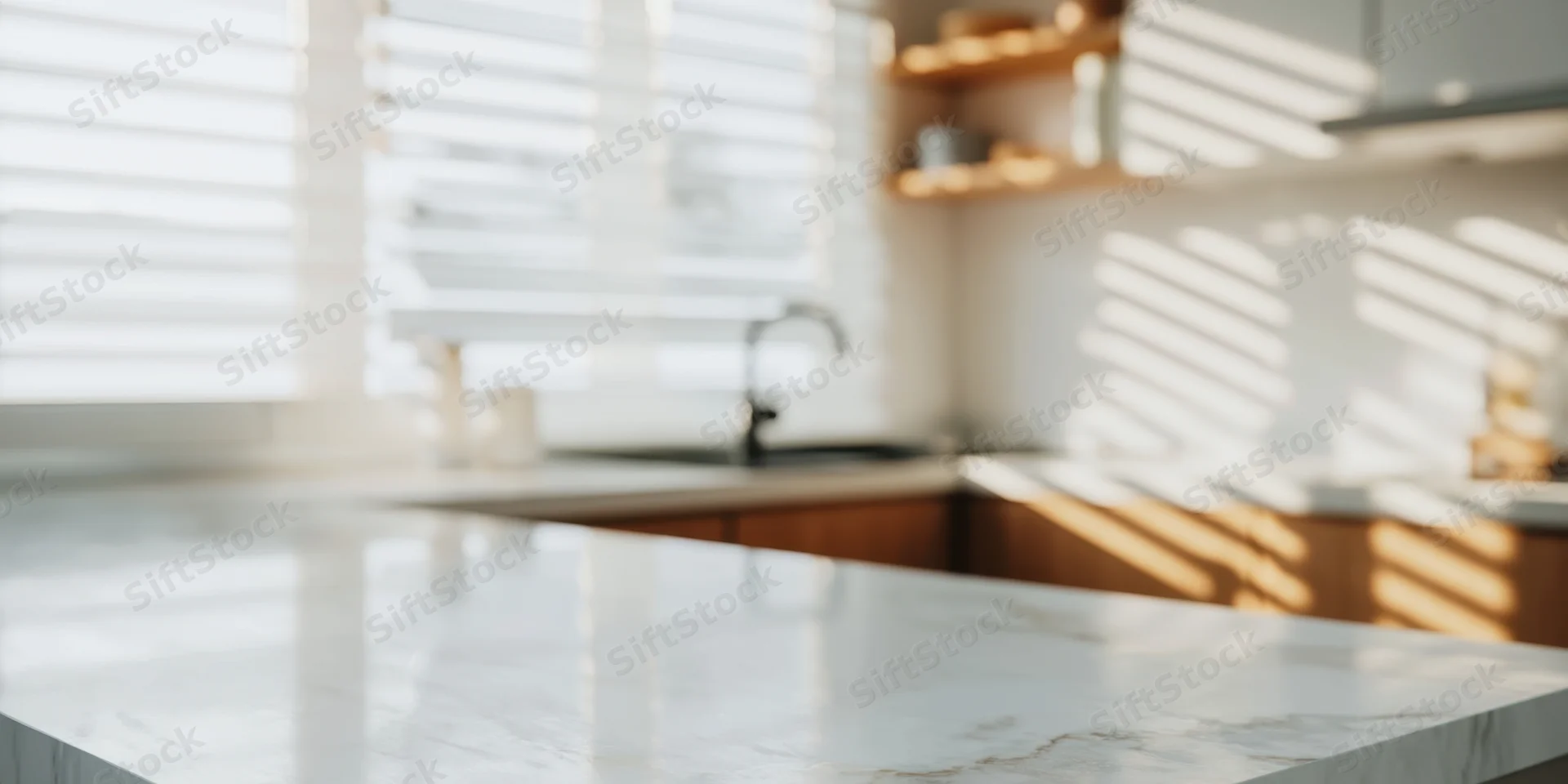 White marble countertop in a minimalist kitchen with sunlight through blinds casting striped shadows