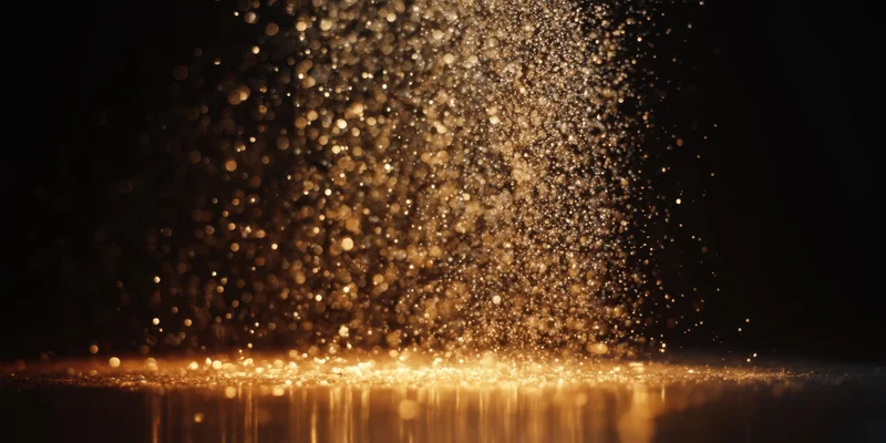 Golden bokeh particles cascading downward over a reflective surface in a dark space