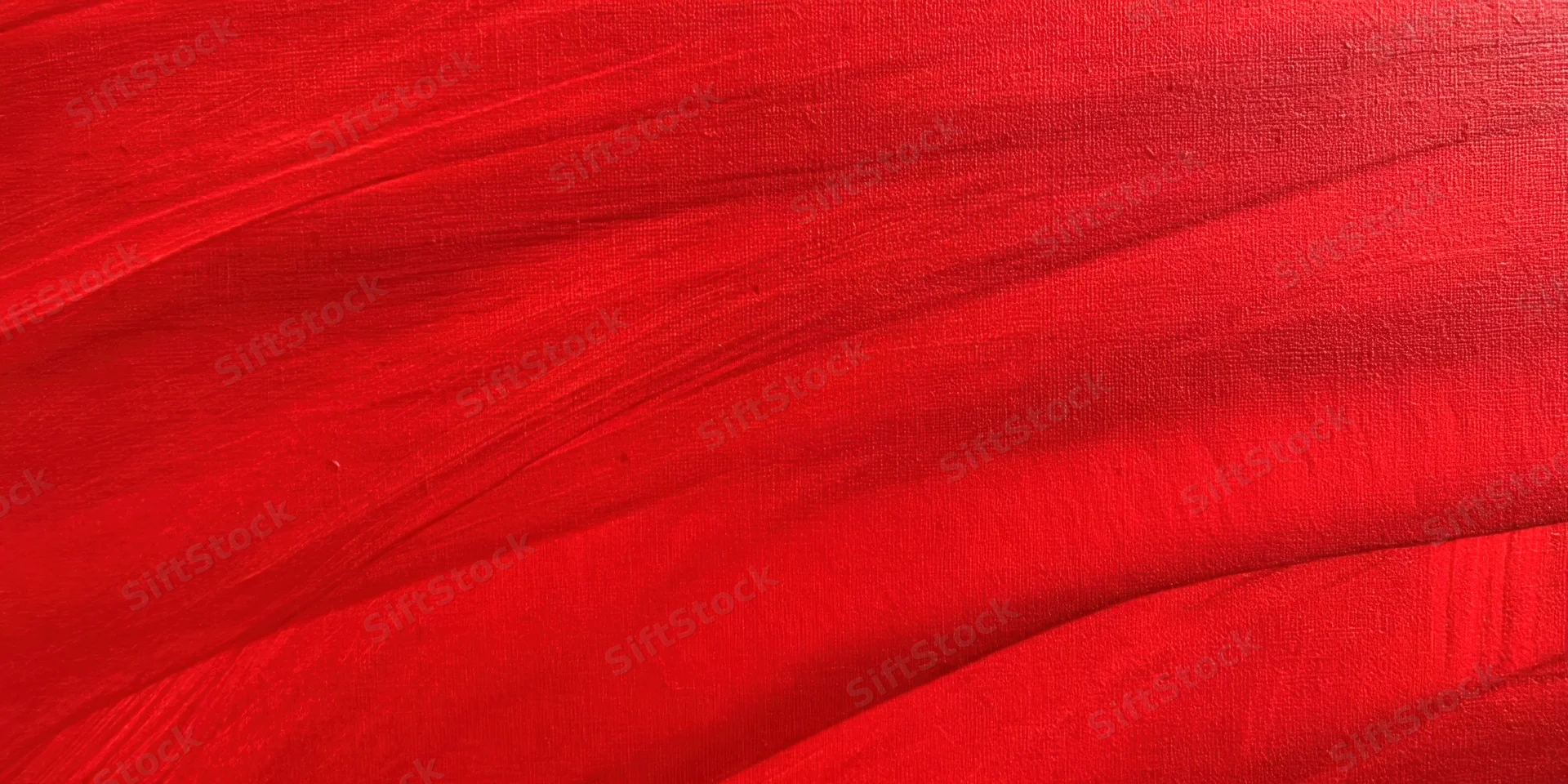Bold red textured surface with sweeping brushstrokes in close-up view