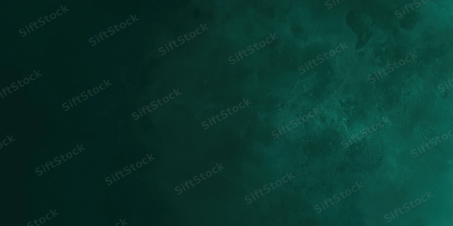 Close-up of a dark emerald green textured surface with soft variations in tone and depth