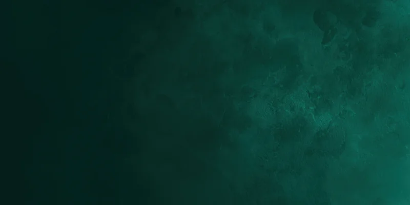 Close-up of a dark emerald green textured surface with soft variations in tone and depth