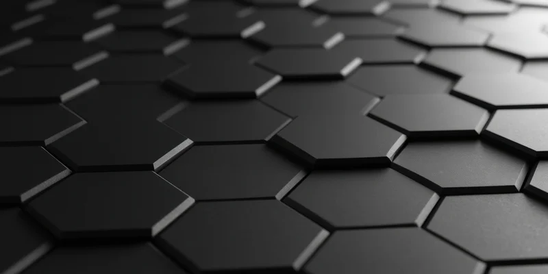 Close-up of dark three-dimensional hexagonal honeycomb pattern with matte finish and subtle lighting depth