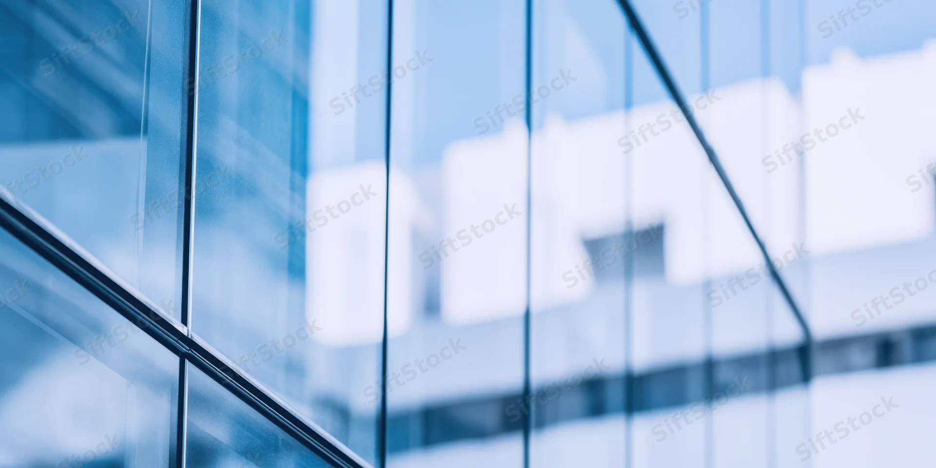Close-up of glass facade with reflections and soft focus on a modern office building exterior