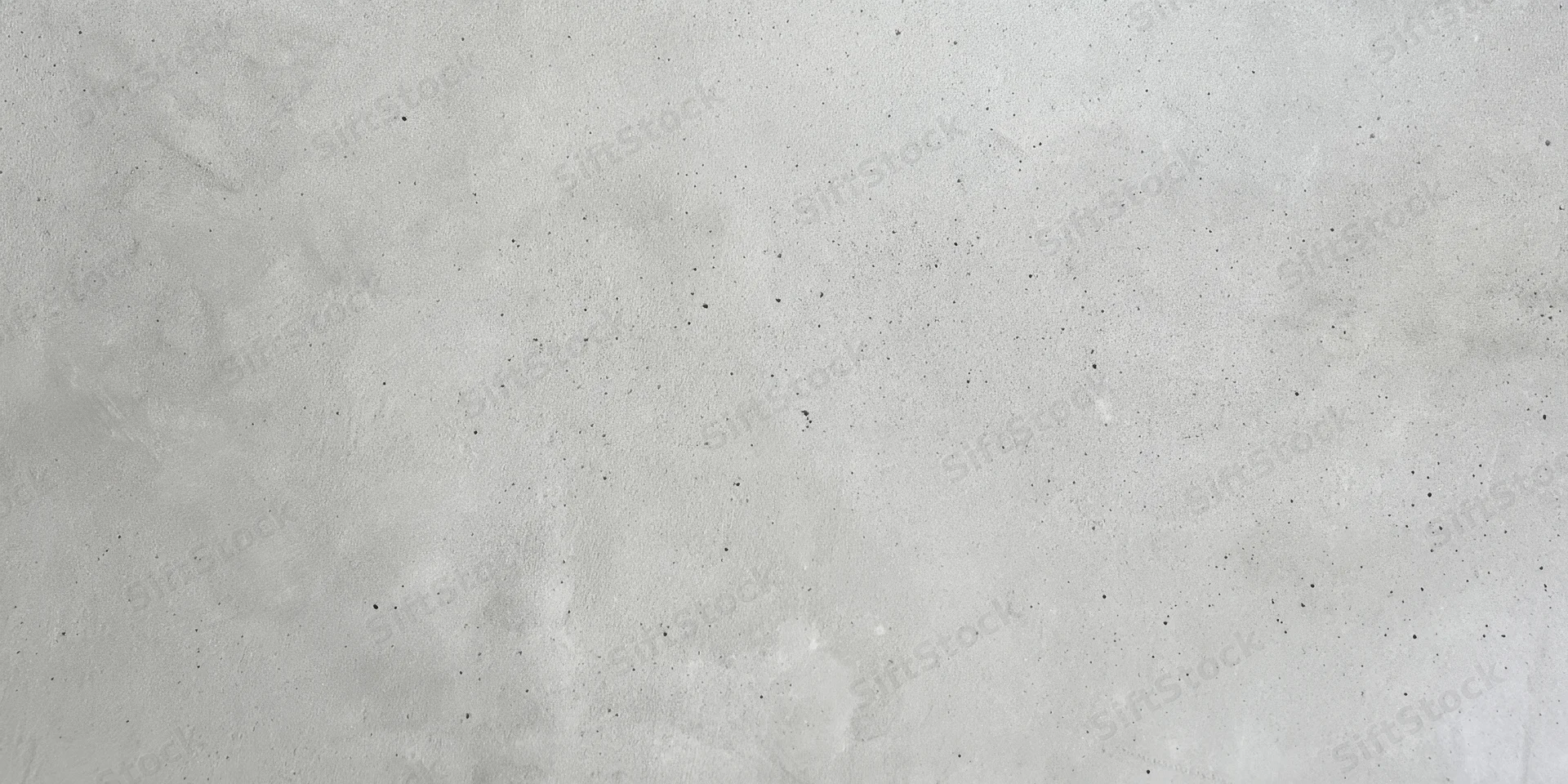Close-up of a light gray concrete wall with a slightly rough texture