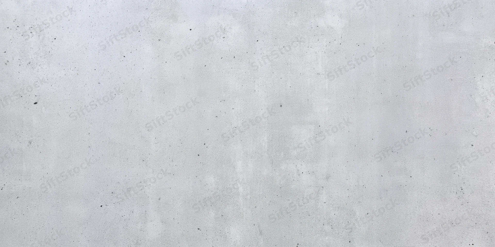 Close-up of a light gray concrete wall with a rough textured surface