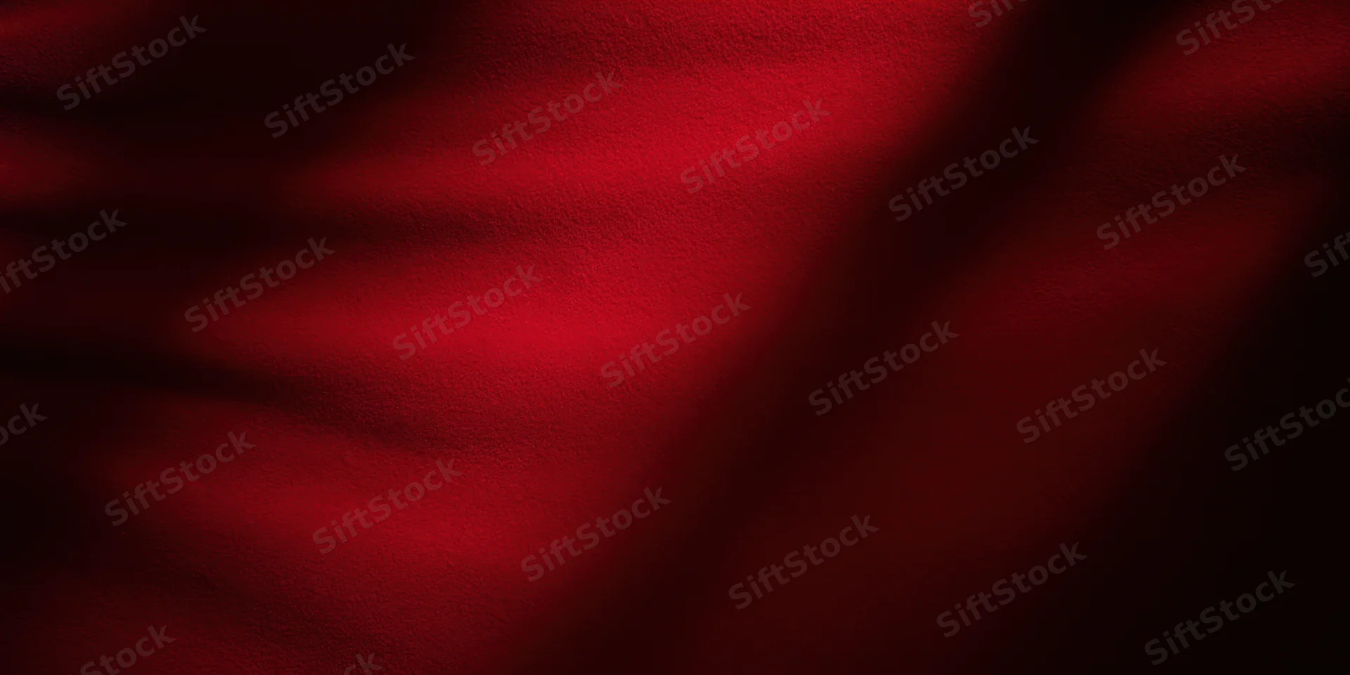 Close-up of rich crimson velvet fabric with soft folds and deep texture