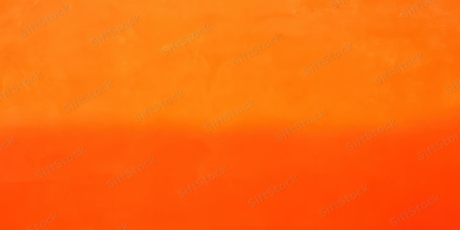 Close-up of a smooth orange surface with soft texture and color gradient