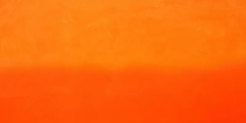 Close-up of a smooth orange surface with soft texture and color gradient