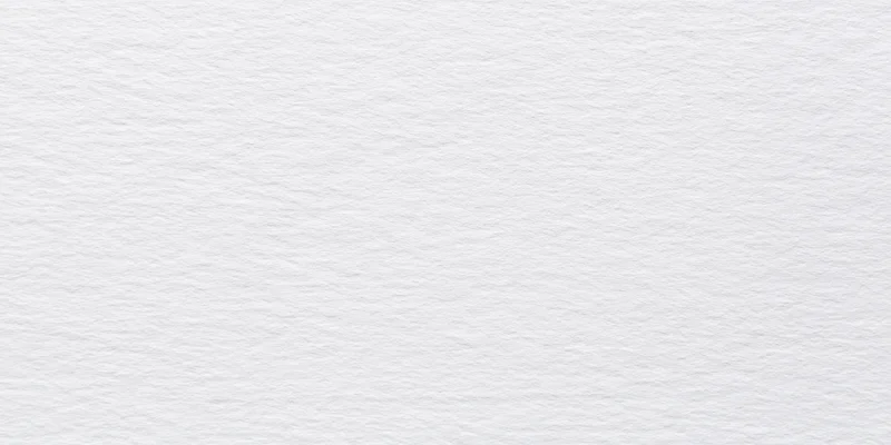 Close-up of a white textured surface with fine grain pattern