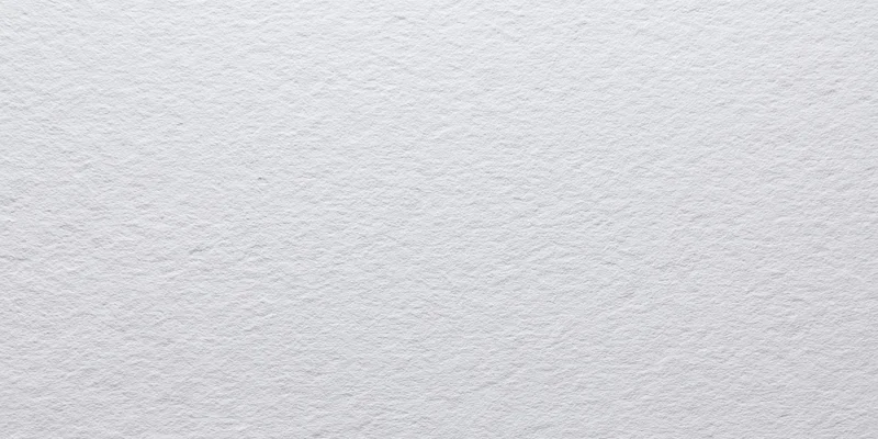 Close-up of a white textured paper surface with fine grain pattern