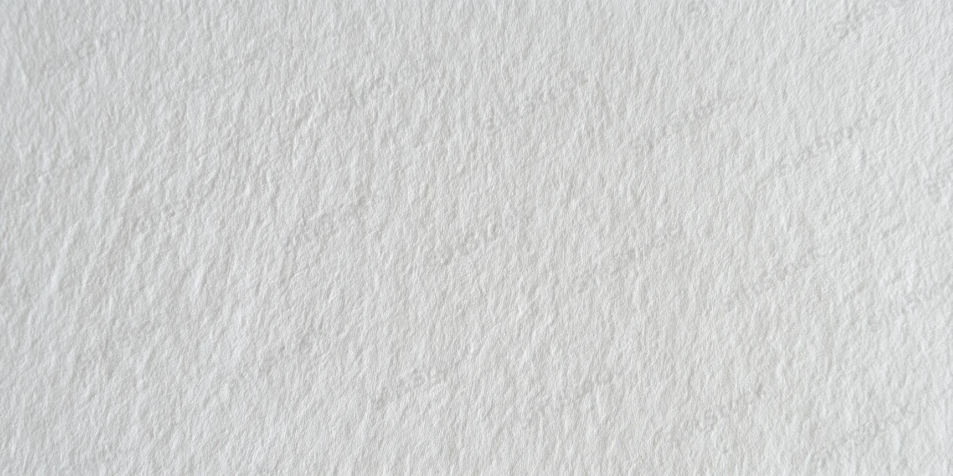 Close-up of a white textured surface with fine grain pattern