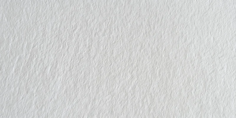 Close-up of a white textured surface with fine grain pattern
