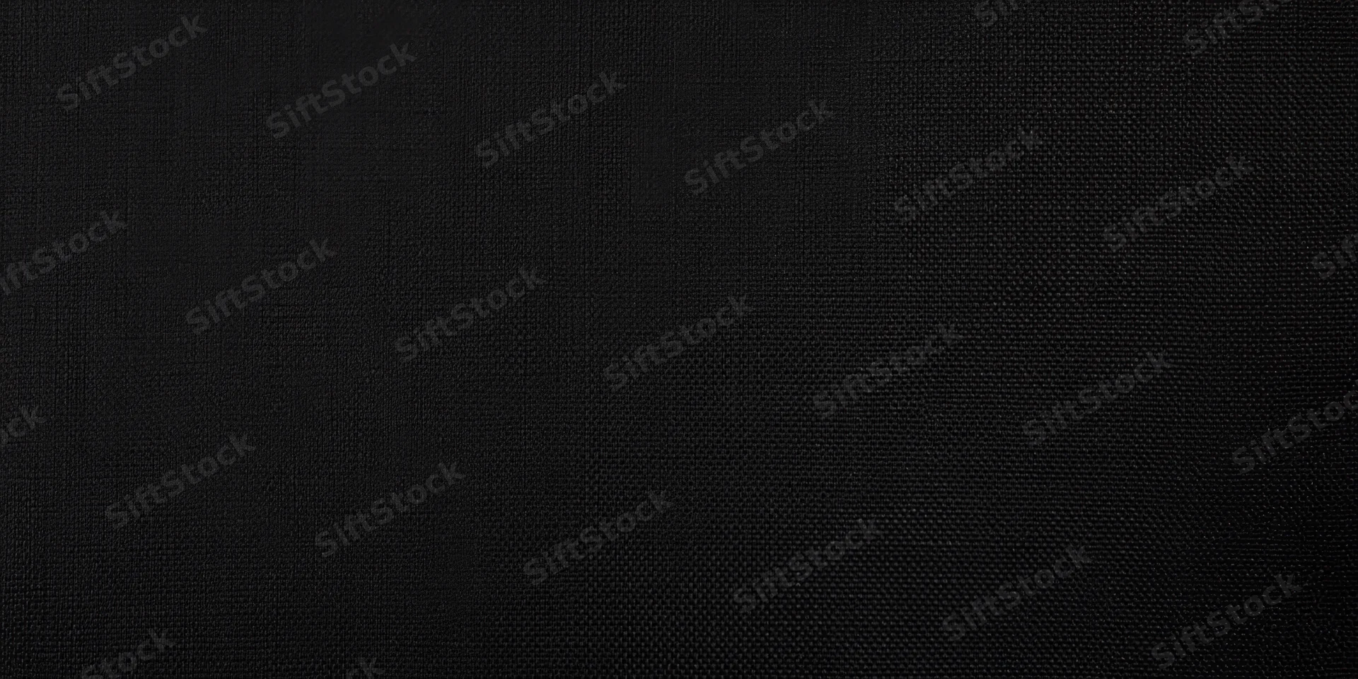 Close-up of black fabric with fine weave pattern filling the frame