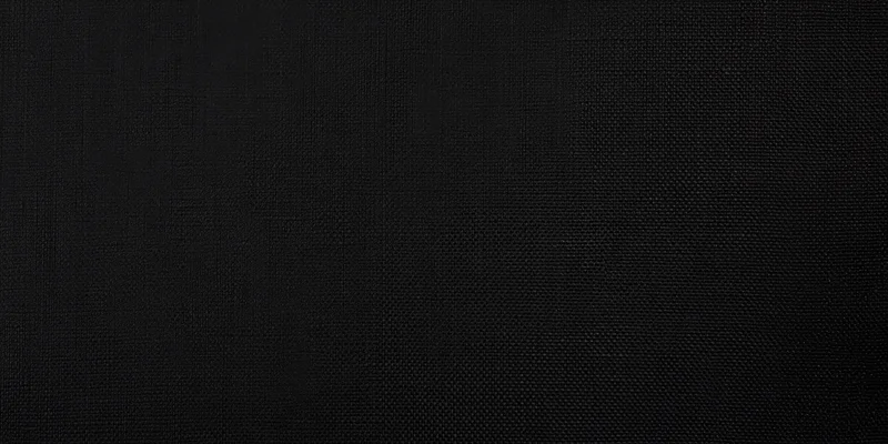 Close-up of black fabric with fine weave pattern filling the frame