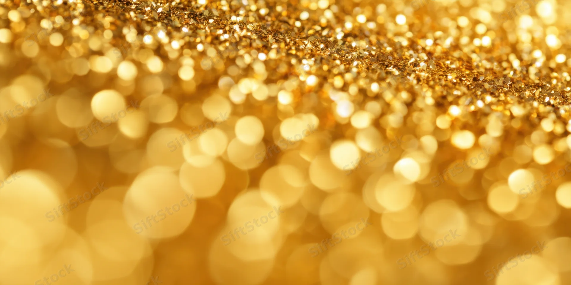 Close-up of shimmering gold glitter with soft bokeh circles in the background