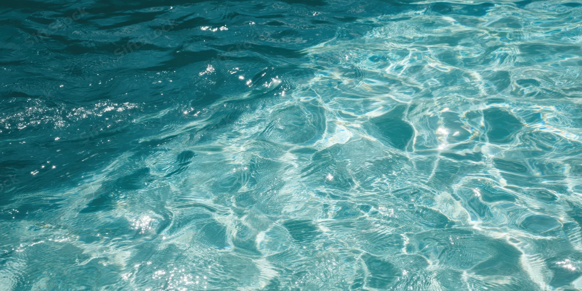 Turquoise pool water with sunlit ripples sparkling on the surface