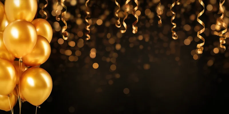Golden balloons clustered on left with hanging streamers and bokeh lights on dark background