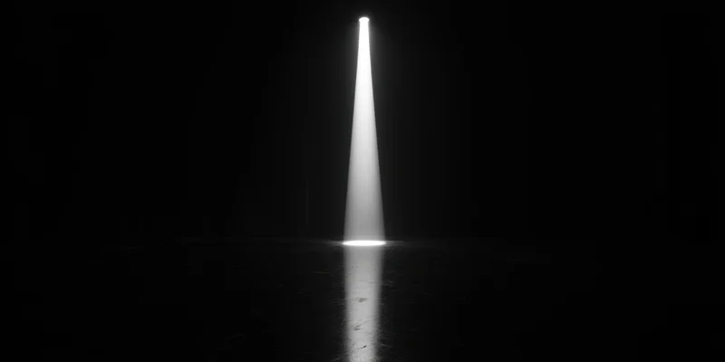 Single spotlight beam on dark empty stage floor