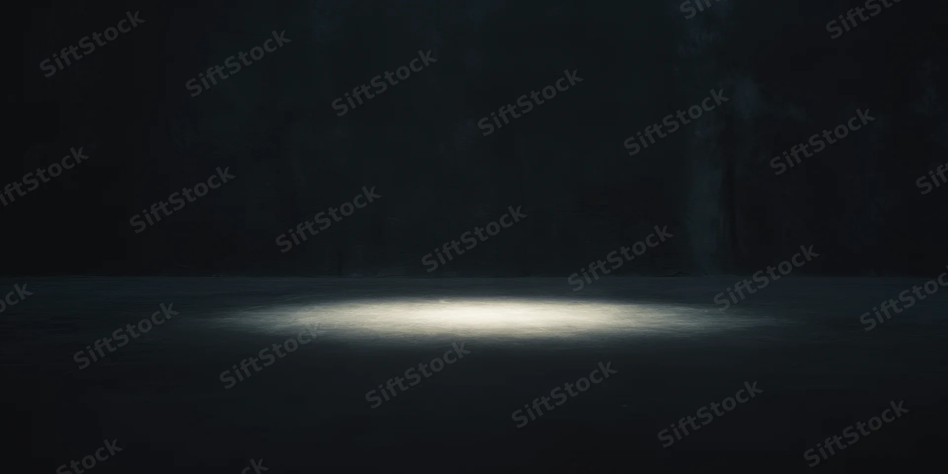 Dimly lit empty studio with spotlight centered on the floor