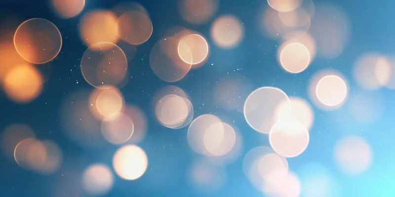 Soft bokeh circles glowing against a blue gradient background