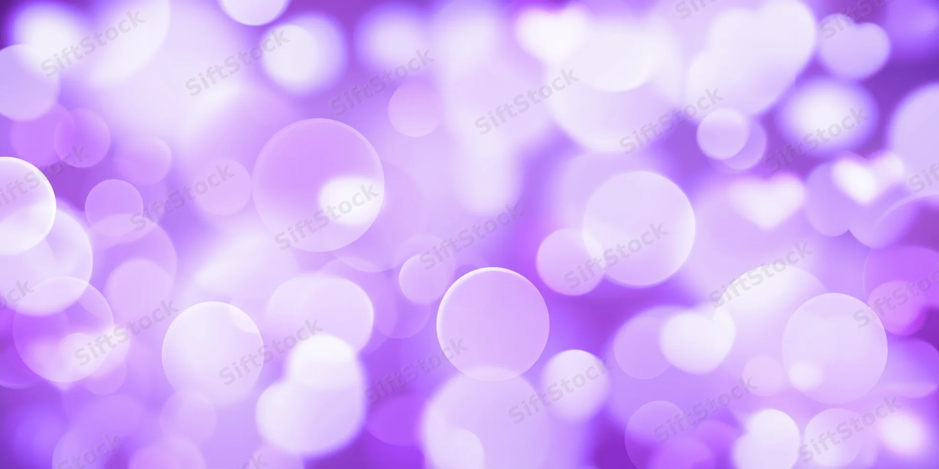 Soft glowing purple bokeh background with circular and heart-shaped lights arranged in a dreamy abstract pattern