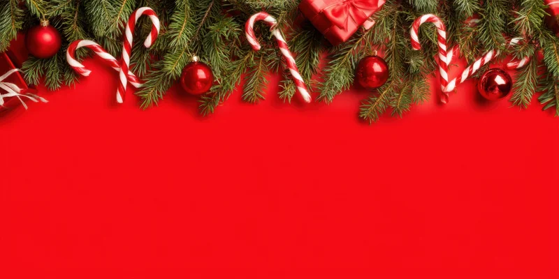 Evergreen branches with red ornaments, candy canes, and gifts arranged as a top border on red background