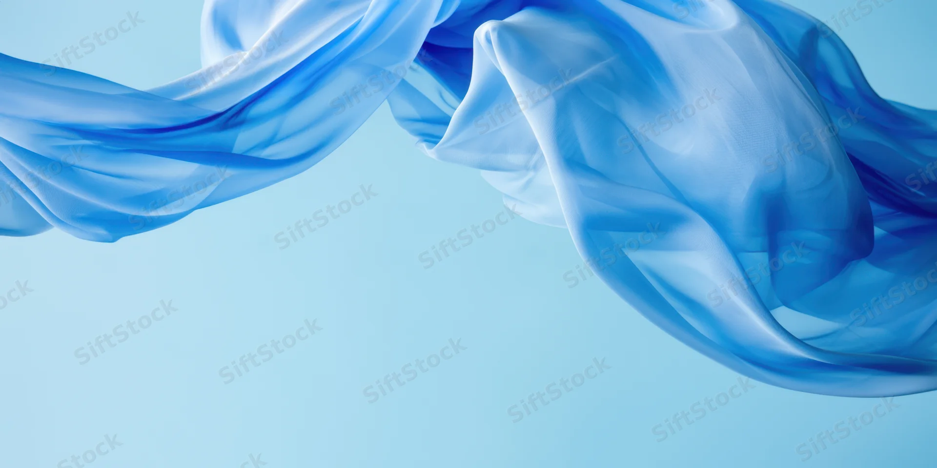 Flowing blue fabric billows through the air against a light blue background