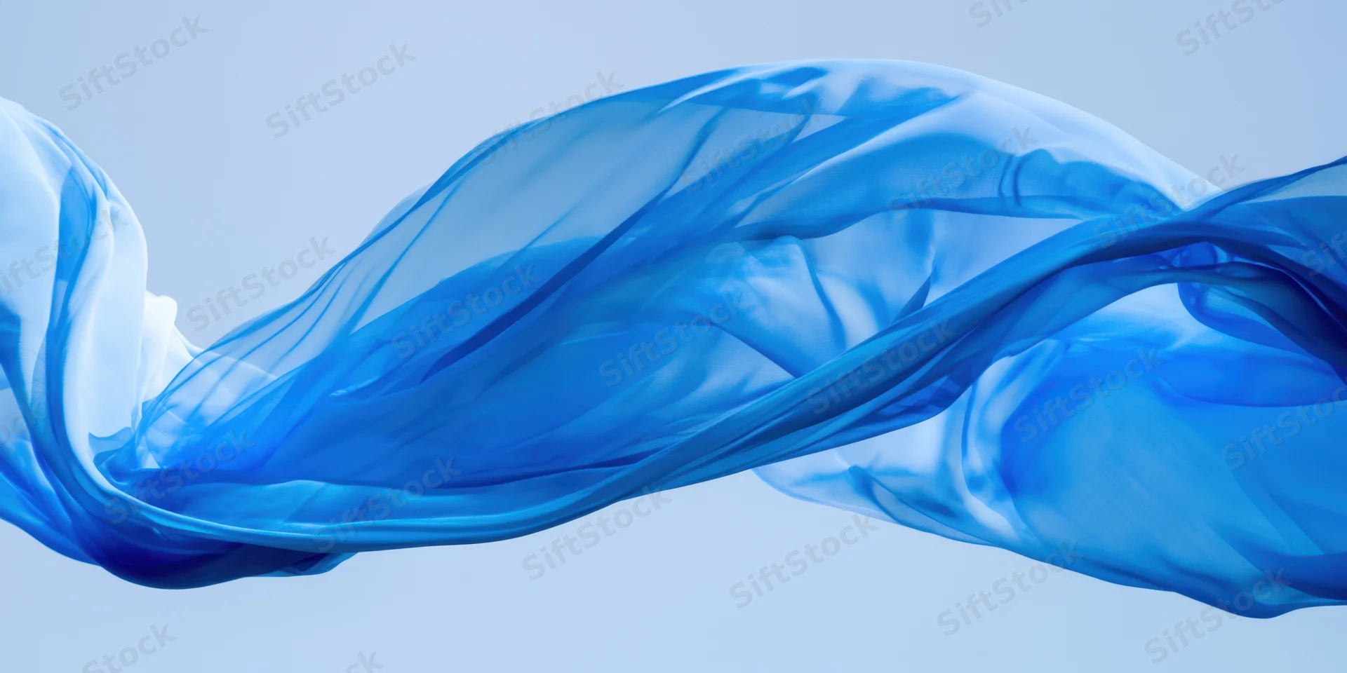 Flowing blue translucent fabric billowing in the air against a light background
