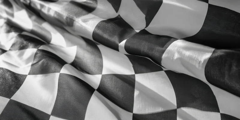 Checkered flag fluttering in wind closeup with folds and sheen