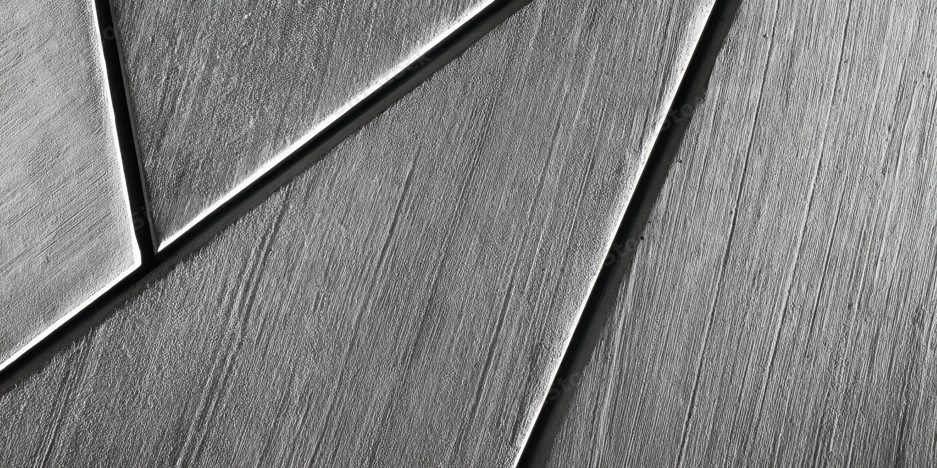 Close-up of a concrete wall with diagonal geometric pattern and textured surface