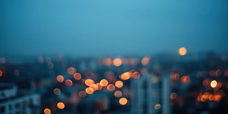 Blurred city lights at night with soft bokeh effect and hazy atmosphere