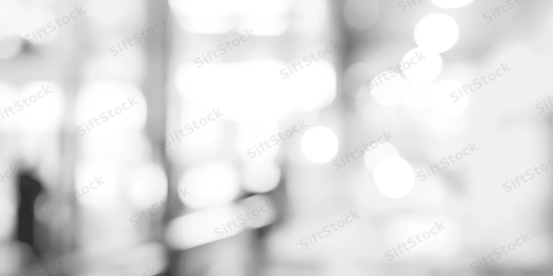 Blurred lights in a high-key grayscale interior space